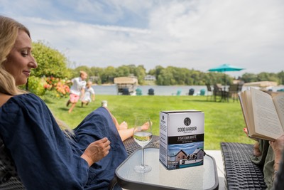 A Woman Relaxing In Her Backyard, Enjoying White Wine in Lake Leelanau, MI 