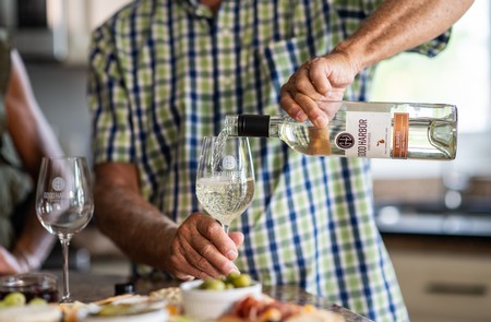 Man serving a Good Harbor Wine in a glass at an occasion in Lake Leelanau, MI
