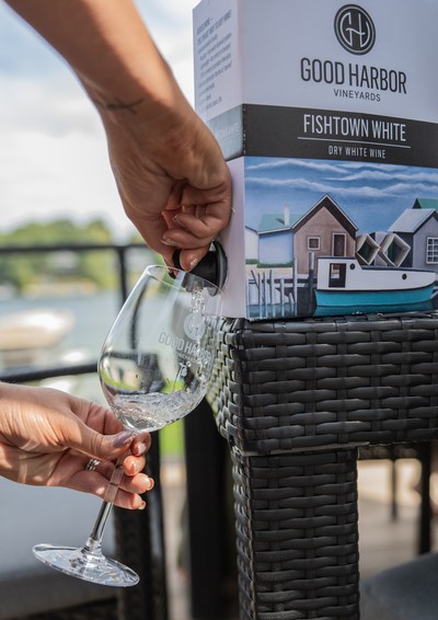 A Woman Pouring White Wine in a Wine Glass located in Lake Leelanau, MI 