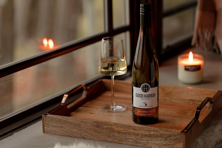 A bottle of wine & a glass elegantly placed on a tray by Good Harbor Vineyards in Lake Leelanau, MI